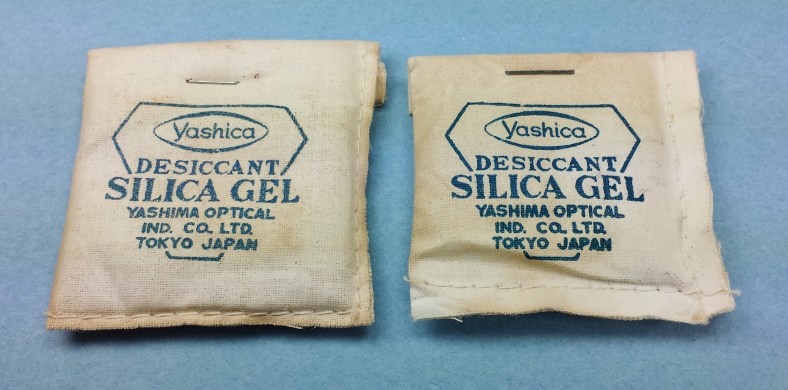 Recently discovered silica gel packs from around 1956 or so. First time I've seen the dual designation of Yashima / Yashica on something as small as these. The company was changing its name from Yashima Optical Industries Company, Limited to Yashica Company, Limited. These were part of a complete original Yashica LM set I recently added to my collection.