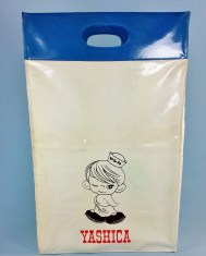 A fun little find recently. Yashica's Sailor Boy found on a vinyl shopping bag from around 1962. Looks like it was a promotional item from Yashica and features the name of the dealer on the reverse side of the bag. The bag stands about 14 inches tall and about 6 inches wide. Made from heavyweight vinyl that has stood the test of time!