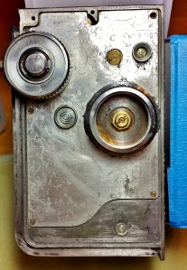 Camera's right side exposed! After numerous hours of scrapping, sanding and cleaning... almost ready for some painting. The bare aluminum body will get a brush coat of zinc chromate sealer/etcher primer. After 60 years of corrosion I want my finish topcoat of satin-black lacquer paint to stay stuck!