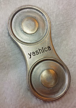 Somewhat corroded original lens cap for the Yashicaflex A-II. A light cleaning removed the corrosion and prepped the surface for some primer.